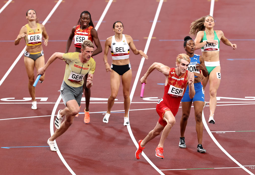 TOKYO, JAPAN - JULY 30: Competitors hand off the baton while competing in the 4x400 Relay Mixed Round 1 on day seven of the Tokyo 2020 Olympic Games at Olympic Stadium on July 30, 2021 in Tokyo, Japan. (Photo by Ryan Pierse/Getty Images)