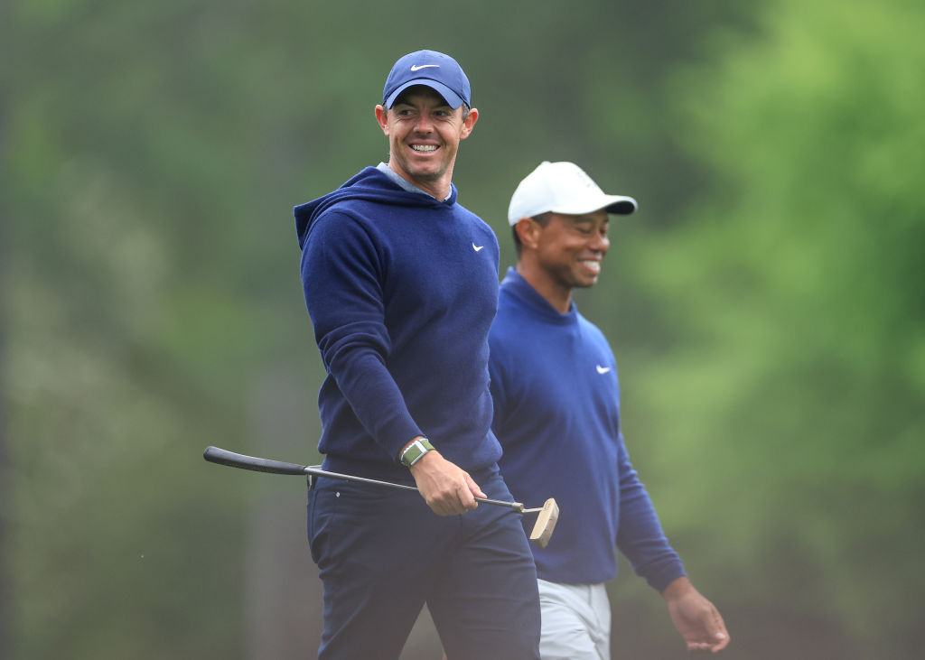AUGUSTA, GEORGIA - APRIL 03: Rory McIlroy of Northern Ireland and Tiger Woods of The United States walk together off the tee on the 12th hole during a practice round prior to the 2023 Masters Tournament at Augusta National Golf Club on April 03, 2023 in Augusta, Georgia. (Photo by David Cannon/Getty Images)