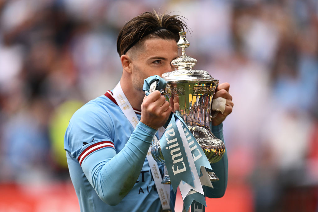 LONDON, ENGLAND - JUNE 03: Jack Grealish of Manchester City kisses the FA Cup Trophy after the team's victory in front of their fans after the Emirates FA Cup Final between Manchester City and Manchester United at Wembley Stadium on June 03, 2023 in London, England. (Photo by Mike Hewitt/Getty Images)