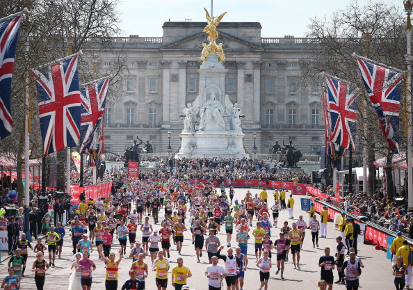 LONDON, ENGLAND - APRIL 21:  Runners in the London Marathon pass Buckingham Palace as they enter the finishing straight on April 21, 2013 in London, England. Thousands of runners are taking part - with some wearing black ribbons as a mark of respect to the Boston victims. Extra police are on duty as an estimated 500,000 people line the streets of the capital.  (Photo by Peter Macdiarmid/Getty Images)