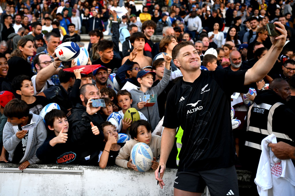 BORDEAUX, FRANCE - SEPTEMBER 18: Jordie Barrett of the All Blacks takes photos with fans following a New Zealand All Blacks training session at Stade Jacques-Chaban-Delmas on September 18, 2023 in Bordeaux, France. (Photo by Hannah Peters/Getty Images)