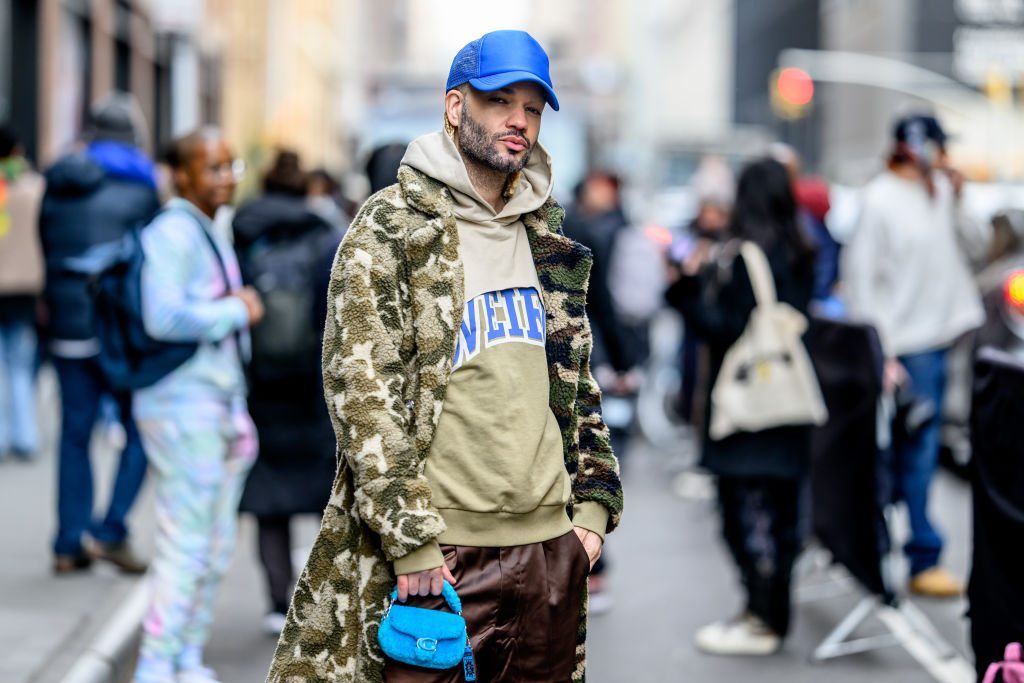 Jason C Peters wears a Coach bag and a fashion Noava sweater outside the Pamella Roland Show at Starrett-Lehigh Building during New York Fashion Week on February 12, 2024 in New York City. (Photo by Roy Rochlin/Getty Images)