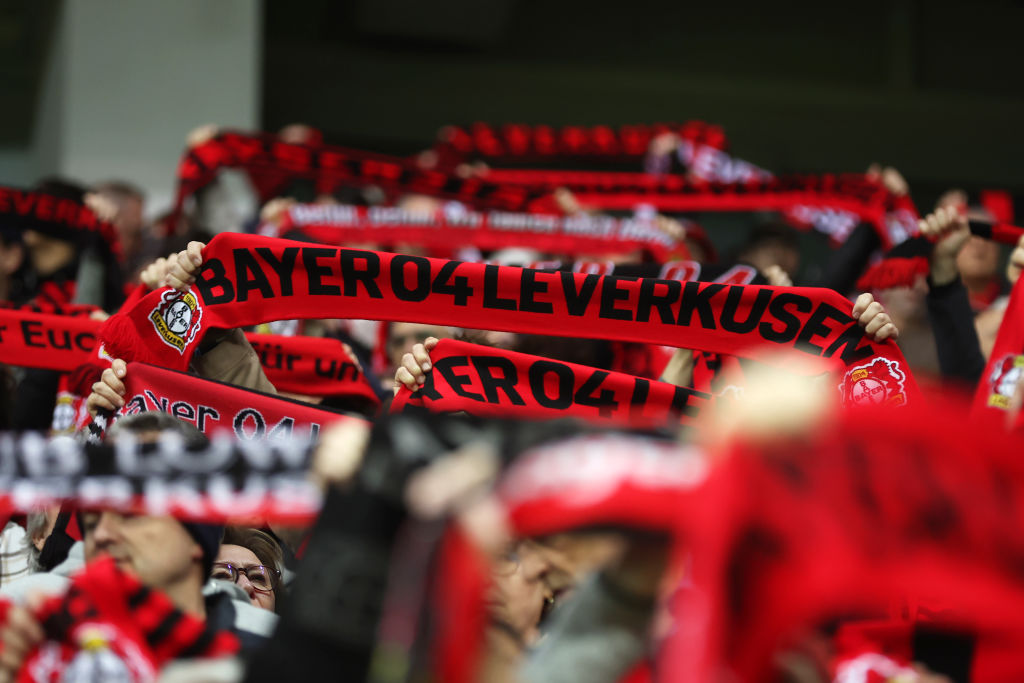 LEVERKUSEN, GERMANY - MARCH 14: Fans of Bayer Leverkusen hold up scarves in support prior to the UEFA Europa League 2023/24 round of 16 second leg match between Bayer 04 Leverkusen and Qarabag FK at BayArena on March 14, 2024 in Leverkusen, Germany. (Photo by Alex Grimm/Getty Images)