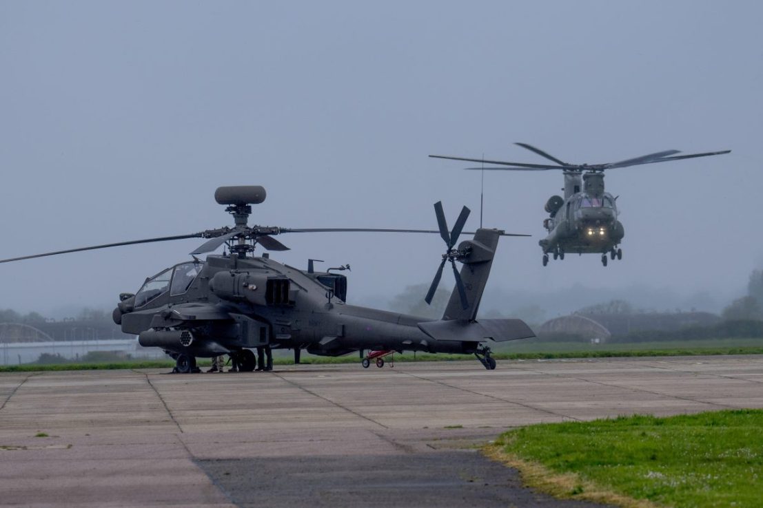 IPSWICH, ENGLAND - APRIL 23: A Chinook prepares to land near an Apache as more than a dozen Apache, Wildcat and Chinook helicopters assemble to take-off together from Wattisham Flying Station in Suffolk for training in Finland and Estonia on Exercise Steadfast Defender 24. On their first NATO deployment, the new Apache variant will take part in Exercise Arrow in Finland, flying strike missions in support of large-scale Finnish Army training. All three helicopter types will be operating together in Estonia under the command of 16 Air Assault Brigade Combat Team, the British Army's global response force, on April 23, 2024 in Ipswich, England. (Photo by Carl Court/Getty Images)