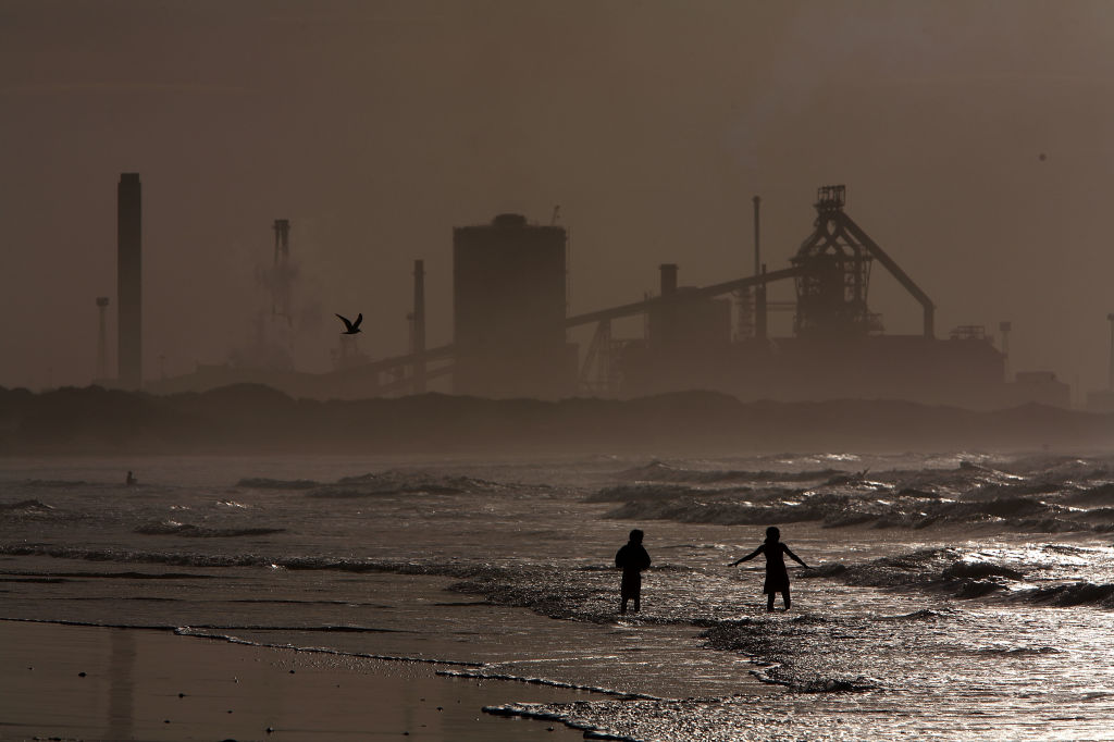 Locals and children play on the surf at high tide on Redcar beach in the shadow of the Corus Steelworks in Teeside, on July 21, 2008, in Middlesborough, England.    (Photo by Christopher Furlong/Getty Images)