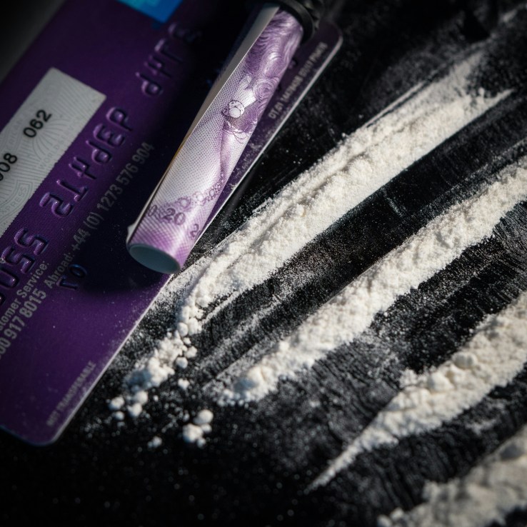 A line of cocaine with a British bank note (don't worry, it's actually baking powder) –
(Photo by Colin Davis on Unsplash)
