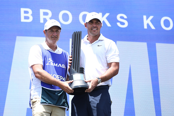 SINGAPORE, SINGAPORE - MAY 05: Brooks Koepka of Smash GC celebrates his win on the podium during day three of the LIV Golf Invitational - Singapore at Sentosa Golf Club on May 05, 2024 in Singapore, Singapore. (Photo by Lionel Ng/Getty Images)