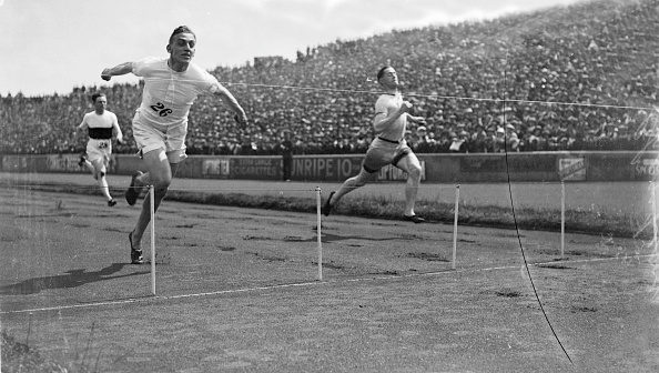 1924:  British sprinter Harold Abrahams crosses the finish line to win the 100 yards race at the AAA Championships. Harold Abrahams (1899 - 1978) the 1924 Paris Olympic 100 metres champion whose feat was later immortalised in the film Chariots of Fire (1981).  (Photo by Central Press/Getty Images)