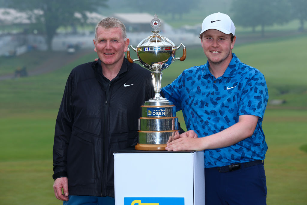 HAMILTON, ONTARIO - JUNE 02: Robert MacIntyre of Scotland poses with the trophy alongside his caddie and father Dougie MacIntyre after winning the RBC Canadian Open at Hamilton Golf & Country Club on June 02, 2024 in Hamilton, Ontario, Canada. (Photo by Vaughn Ridley/Getty Images)