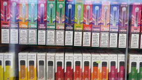 Imperial Brands vape products displayed with declining cigarette sales chart in a business news context