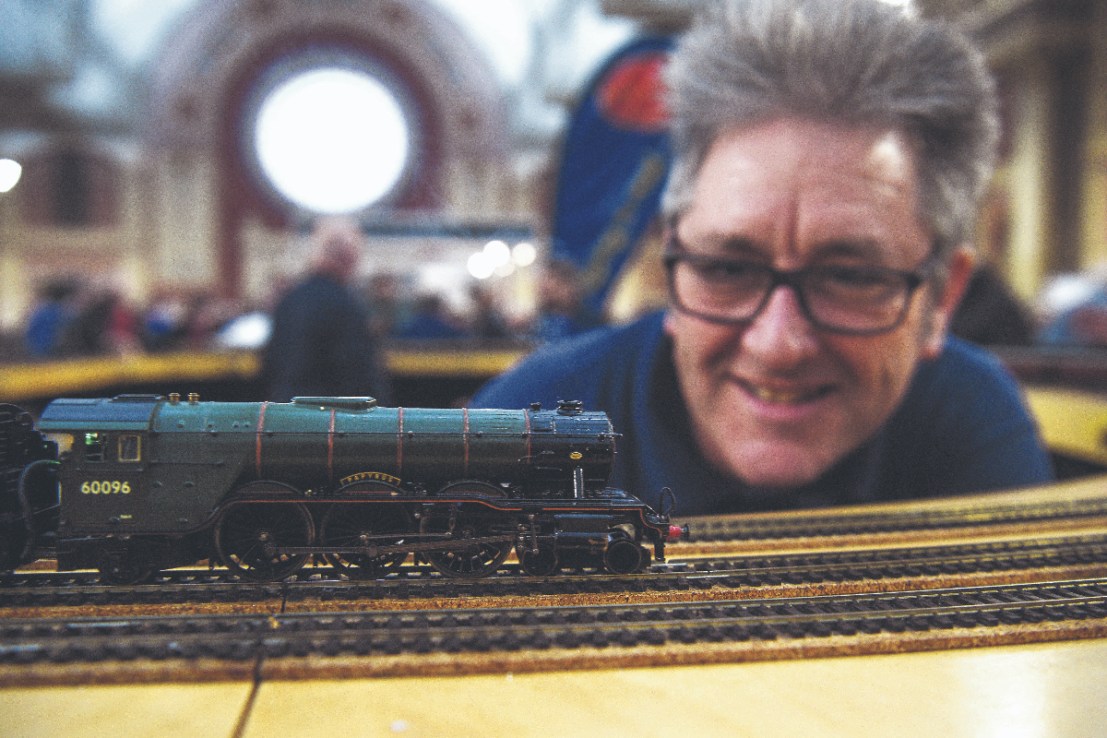 A model engineer looks at a Hornby Pullman model train at the London Model Engineering Exhibition at Alexandra Palace, London.