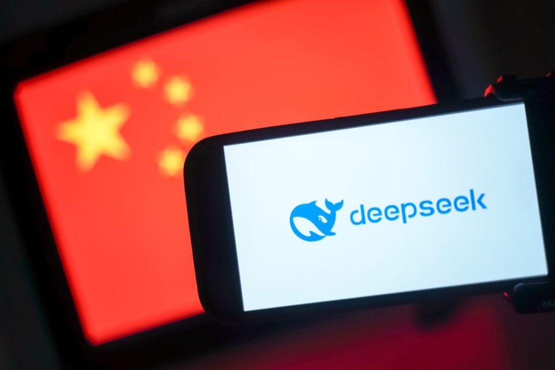 HONG KONG, CHINA - JANUARY 28: In this photo illustration, the DeepSeek logo is seen on a phone in front of a flag of China on January 28, 2025 in Hong Kong, China. Global tech stocks have plummeted following the emergence of DeepSeek, a Chinese AI startup that has developed a competitive AI model at a fraction of the cost of its US rivals, sparking concerns about the high valuations of tech giants like Nvidia. This development has led to significant declines in tech shares across Asia and Europe, with markets in both regions experiencing notable losses as investors reassess the AI landscape and its potential impact on the industry's future. (Photo illustration by Anthony Kwan/Getty Images)