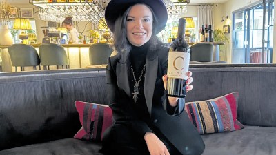 Lighter chilled Claret wine bottle on a table with a glass, capturing the trend of enjoying Brit-favorite wines differently