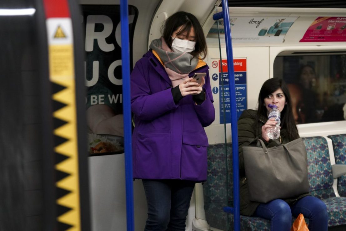Passenger on the London Underground with phone