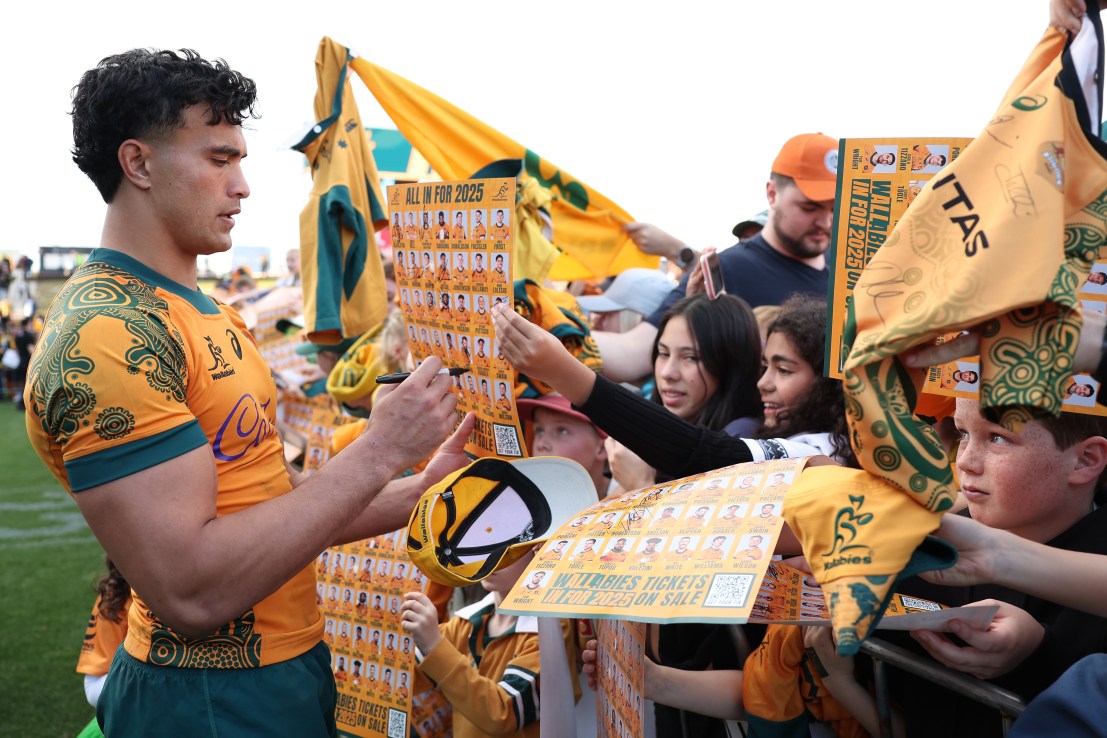 NEWCASTLE, AUSTRALIA - JULY 06: Joseph-Aukuso Suaalii of the Wallabies signs autographs for fans after the International Test match between Australia Wallabies and Fiji at McDonald Jones Stadium on July 06, 2025 in Newcastle, Australia. (Photo by Matt King/Getty Images)