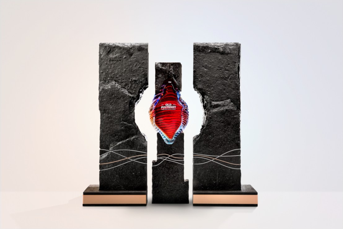 Old Pulteney's Polaris, a one-of-a-kind 47-year-old single malt whisky contained in hand-blown blue glass bottle, featuring inciso cuts to mimic the North Sea’s choppy waters, sits inside a structure of Caithness Slate.