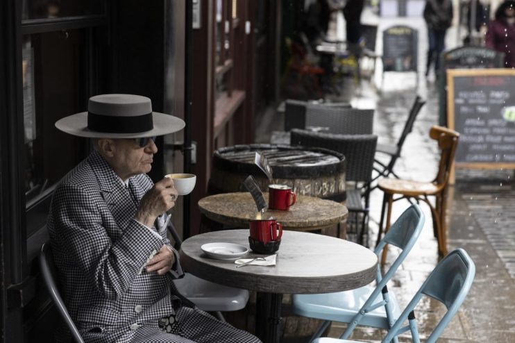 LONDON, UNITED KINGDOM - MAY 17: A man drinks a coffee at a cafe in Soho on May 17, 2021 in London, United Kingdom. From today, covid restrictions on indoor activities and household mixing ease across most of the UK, with indoor food and entertainment venues allowed to reopen across England and Wales, and small in-home meetings permitted once again in England and Scotland. Hugging is also once again allowed between close family and friends across the UK, except in Northern Ireland, where they remain in place until at least May 24. (Photo by Dan Kitwood/Getty Images)