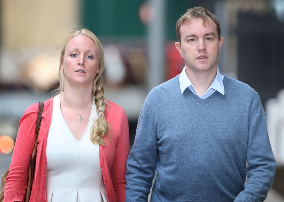 A man and a woman walking down the street