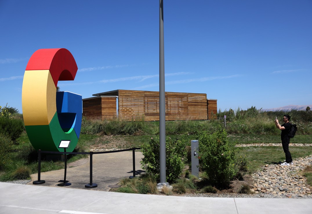 MOUNTAIN VIEW, CALIFORNIA - AUGUST 13: A visitor takes a picture of a Google logo displayed in front of company headquarters during the Made By Google event on August 13, 2024 in Mountain View, California. Google announced new Pixel phones, watches and AI features at the event. (Photo by Justin Sullivan/Getty Images)