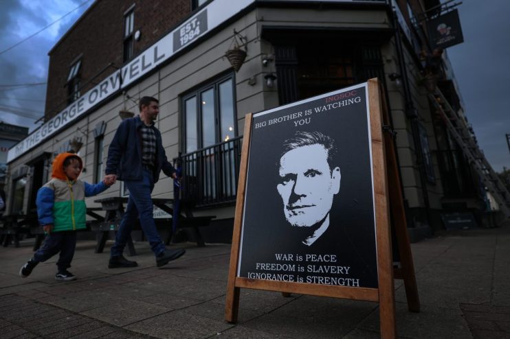 LIVERPOOL, ENGLAND - SEPTEMBER 27:A poster is seen of Britain's Prime Minister Keir Starmer at The Two helmets pub in New Brighton in protest against Labours digital ID policy on September 27, 2025 in Liverpool, England. (Photo by Jeff J Mitchell/Getty Images)