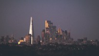 City of London skyline with modern skyscrapers under a clear blue sky, showcasing iconic financial district architecture