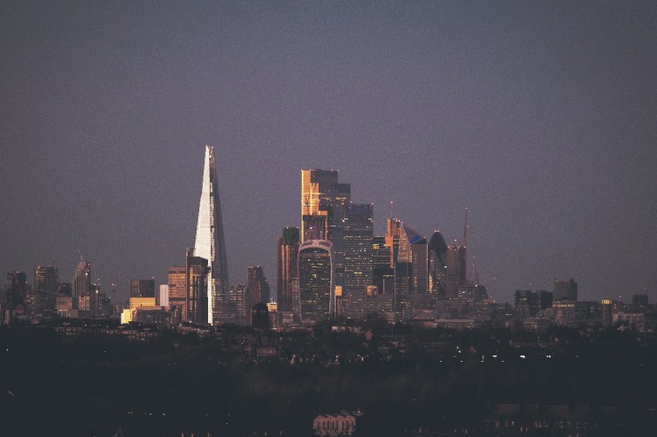 City of London skyline with modern skyscrapers under a clear blue sky, showcasing iconic financial district architecture