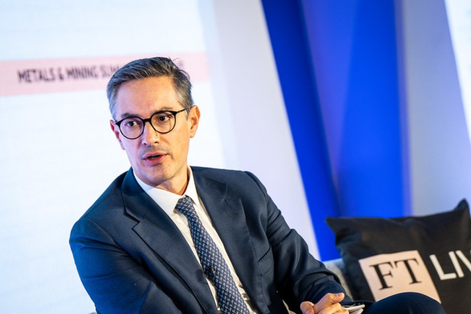 Breaking news event with large crowd gathered at city square, diverse individuals holding banners, vibrant urban backdrop
