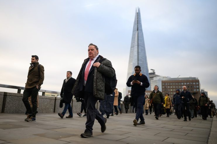 LONDON, UNITED KINGDOM - JANUARY 31: The Shard is seen on the horizon as commuters cross London Bridge during the morning rush hour on January 31, 2023 in London, United Kingdom. The IMF reports that the UK economy will contract by 0.6% in 2023, as opposed to the previous prediction it might grow, and will perform worse than many other advanced economies, including Russia.The cost of living continues to hit households with grocery inflation for the first four weeks of 2023 rising to 16.7% which would add a further £788 per year to family food bills. (Photo by Leon Neal/Getty Images)