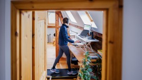 Getty Images logo on a smartphone screen with blurred financial data chart in the background, illustrating stock market tr...