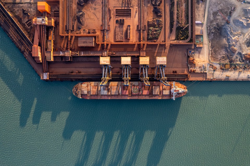 Business professionals discussing strategy at a conference table in a modern office setting, emphasizing teamwork and coll...