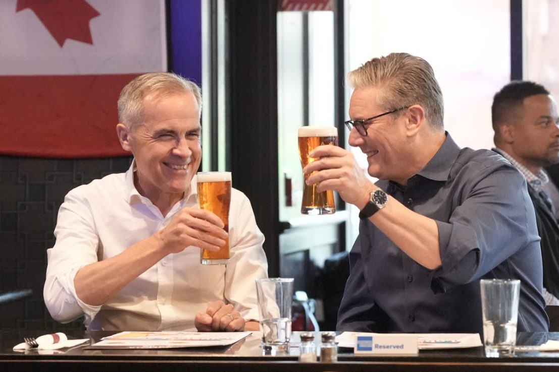 Keir Starmer and Canadian Prime Minister Mark Carney have a beer at the Royal Oak pub in Ottawa, Canada (Photo by Stefan Rousseau / POOL / AFP) (Photo by STEFAN ROUSSEAU/POOL/AFP via Getty Images)
