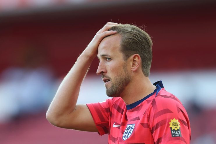 Getty Images logo on a smartphone screen with blurred financial graphs in the background, symbolizing media industry dynam...