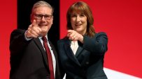 LIVERPOOL, ENGLAND - SEPTEMBER 29: Prime Minister Keir Starmer and Chancellor of the Exchequer Rachel Reeves react on stage during day two of the Labour Party conference at ACC Liverpool on September 29, 2025 in Liverpool, England. The Labour Conference is being held against a vastly different backdrop to last year when the party had swept to power in a landslide general election victory. A year on and polling shows three quarters of Britons (74-77%) say they have little to no trust in the party on the cost of living, immigration, taxation, managing the economy, representing people like them, or keeping its promises. (Photo by Jeff J Mitchell/Getty Images)