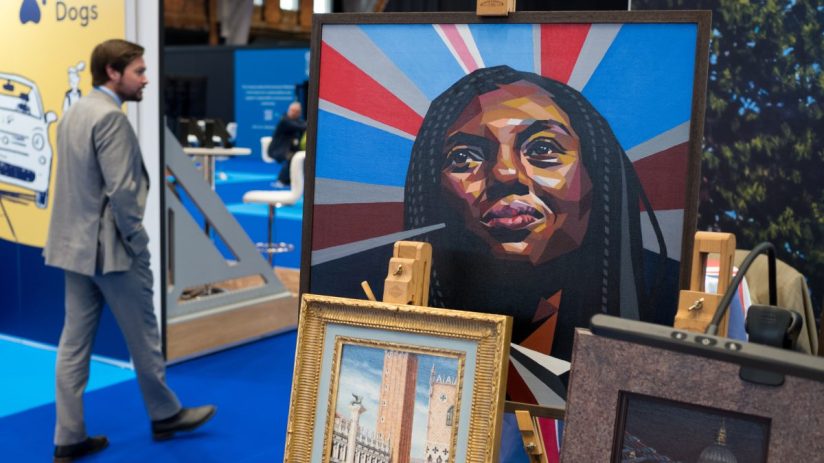 MANCHESTER, ENGLAND - OCTOBER 05: A man walks past a stall selling artwork on the first day of the Conservative party conference on October 05, 2025 in Manchester, England.Kemi Badenoch goes into her first conference as party leader with current polling putting the Conservative Party in fourth place behind Reform, Labour and the Liberal Democrats. (Photo by Ian Forsyth/Getty Images)