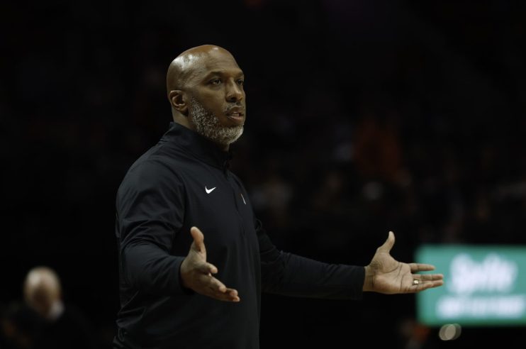 GettyImages 2241110618 shows a business meeting with diverse executives discussing strategies in a modern conference room.