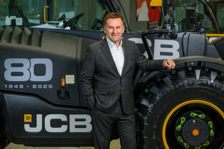 Graeme Macdonald in a business setting, dressed professionally, engaging in a discussion on industry trends and market ins...