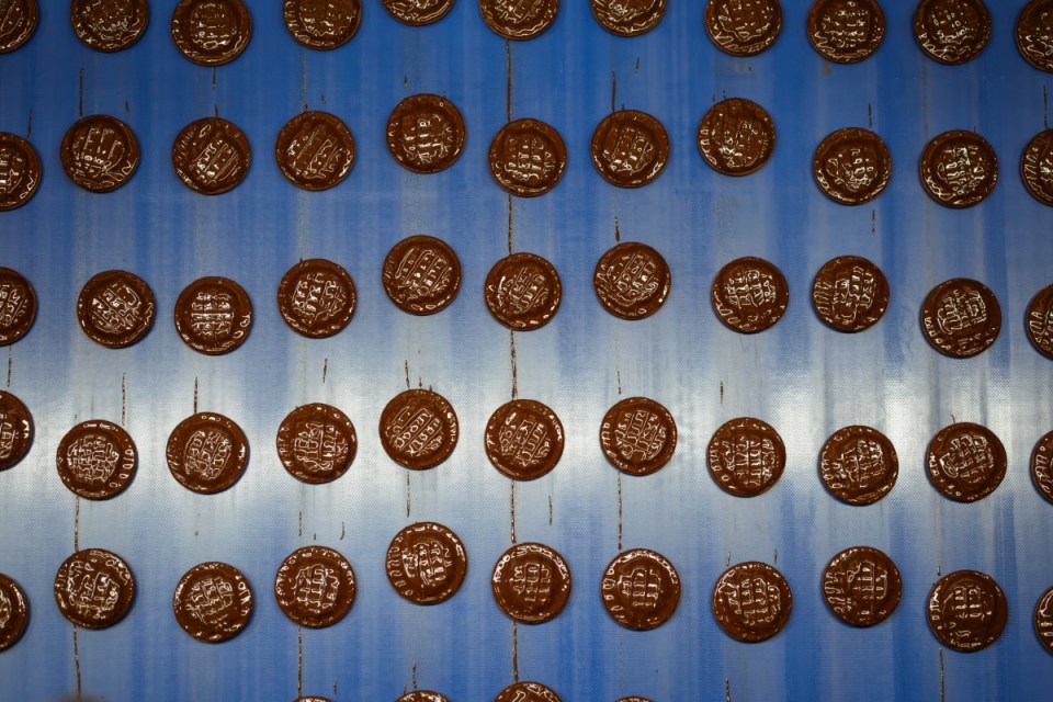 Jaffa Cakes arranged on a table showcasing their distinctive layers of sponge, orange-flavored jelly, and chocolate coating