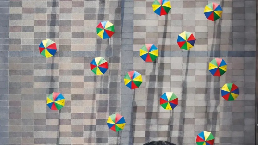 Legal and General building facade with prominent company logo, reflecting a clear blue sky and urban surroundings