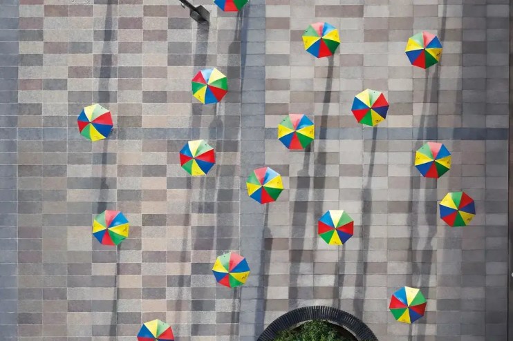Legal and General building facade with prominent company logo, reflecting a clear blue sky and urban surroundings