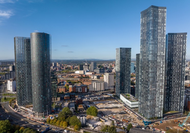 Manchester cityscape featuring iconic architecture and bustling streets, highlighting urban development and vibrant city l...