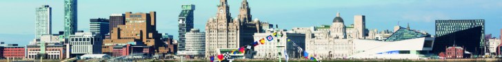 Mersey Ferry Snowdrop adorned in vibrant Dazzle design sailing on the River Mersey against a clear blue sky