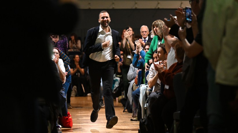 Zack Polanski at a press event discussing recent political developments and green initiatives in a business setting