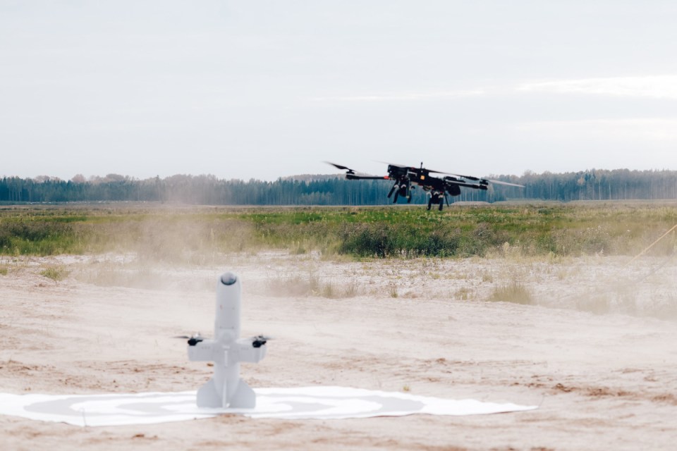 Aerial view of a drone flying over a scenic landscape in Latvia, highlighting technology use in Eastern European environments