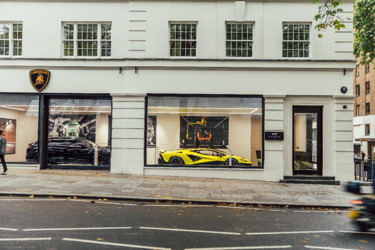 Breaking news event with people gathered at a press conference, microphones on podium, journalists taking notes and photos