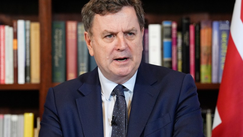 Breaking news or business event with professionals in discussion at a conference table, highlighting teamwork and strategy