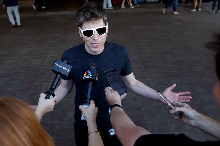 Sam Altman speaking at a tech conference, emphasizing AI innovation and potential, wearing a suit and gesturing passionately.