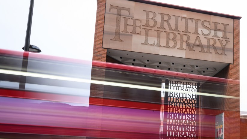 Exterior view of the British Library in London, showcasing its iconic architecture and entrance area, on a sunny day.