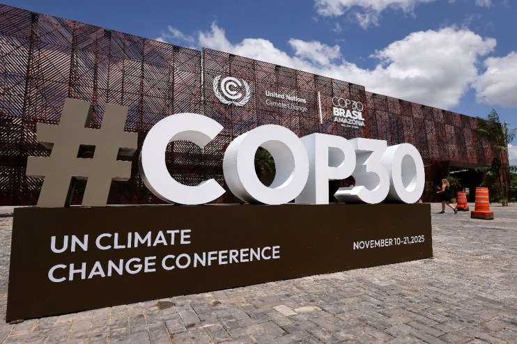 Delegates discussing climate policies at COP30 summit 2023, highlighting international efforts for sustainable development.