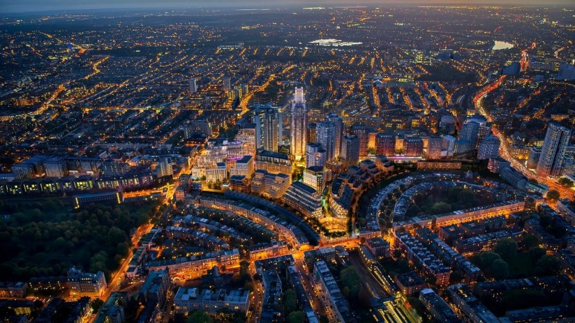 Aerial view of Earls Court Masterplan at dusk showcasing urban development and architectural layout in London