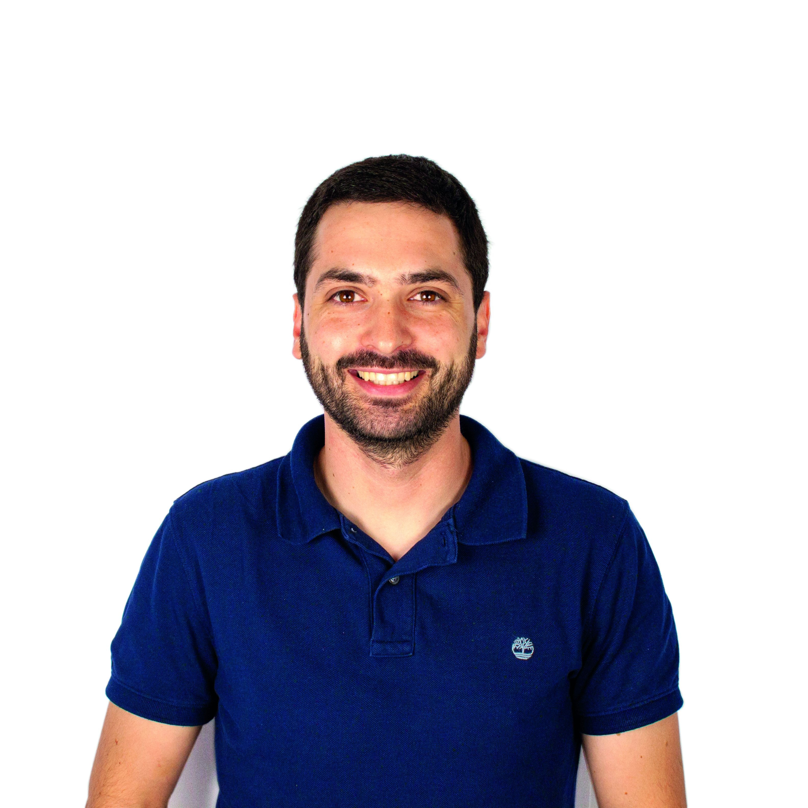 Frederico Carpinteiro speaking at a business conference, wearing a suit, highlighting key points on a presentation screen